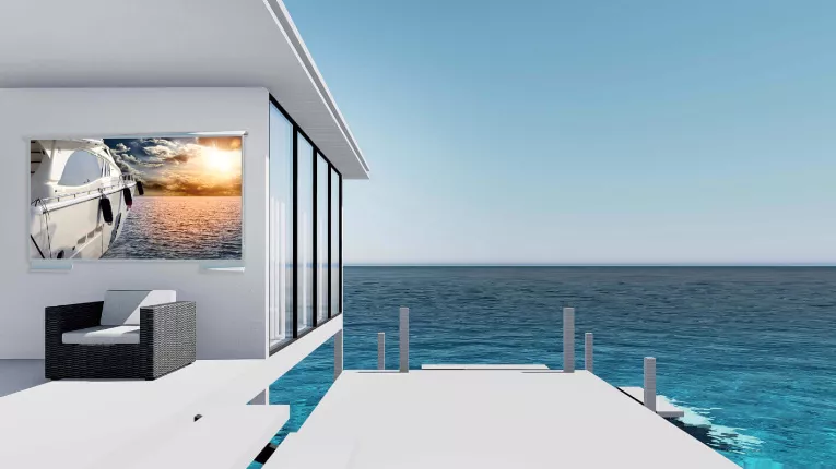 Modern seaside house with a glass window, featuring a wall-mounted outdoor TV.